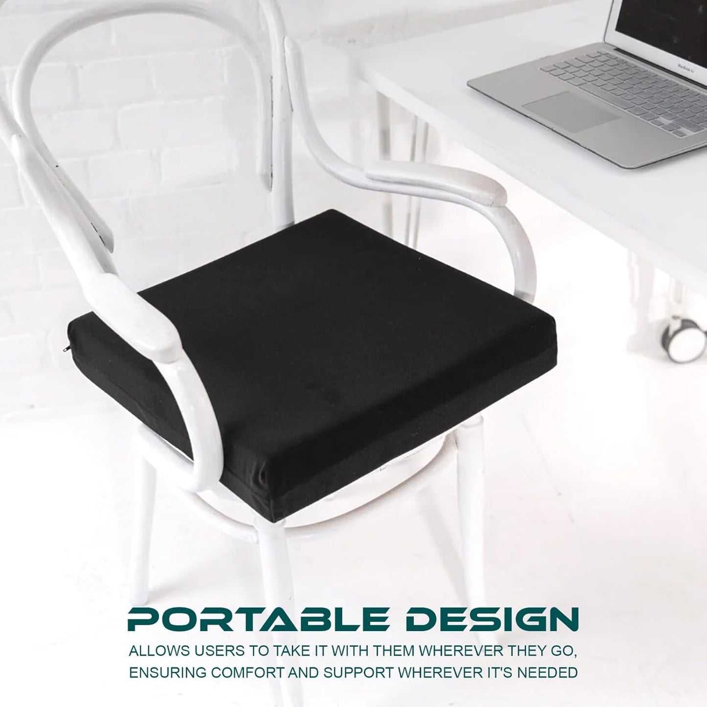 Black seat cushion on a white chair with a laptop on a table in the background.
Telling that the cushion is portable