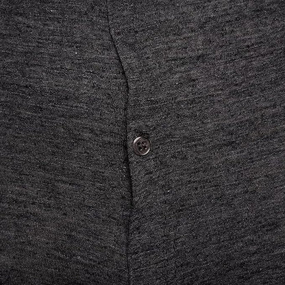 Close-up of a dark gray buttoned shirt with a button detail.