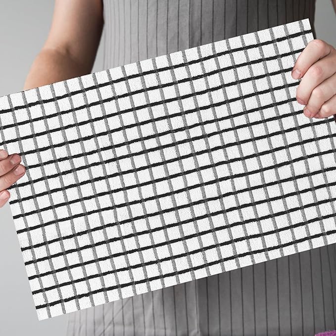 A women holding a terry tea cotton towel which is highly obsorbent 