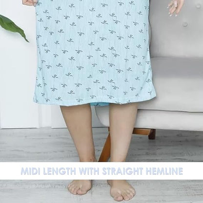 Light blue dress with a subtle pattern worn by a person, sitting on a gray couch.