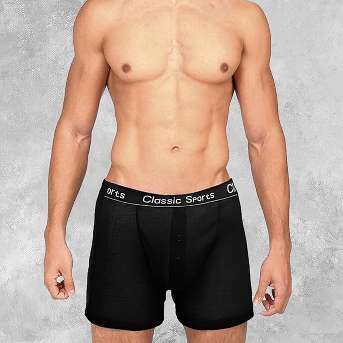 Man wearing black boxer briefs with 'Classic Sports' waistband on a gray background