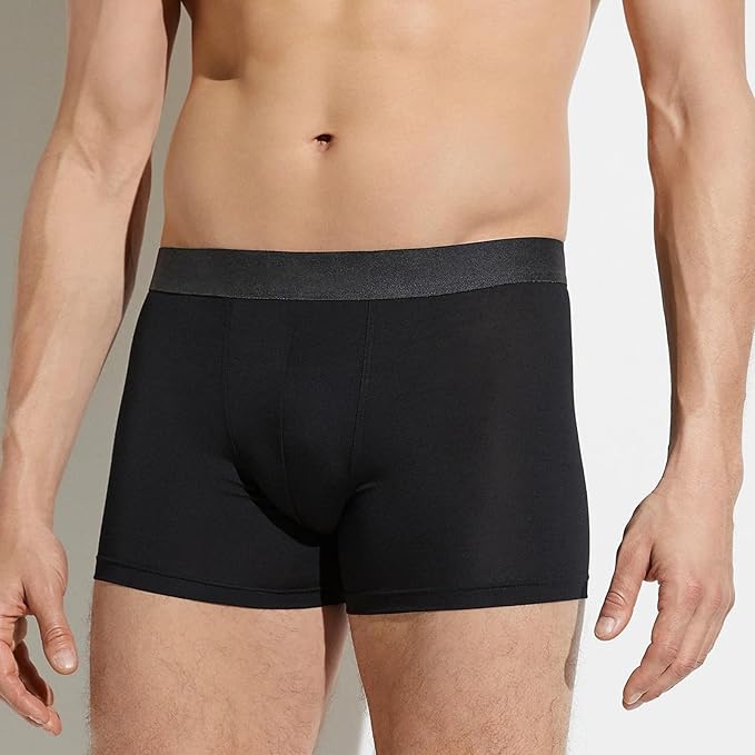 Black boxer briefs worn by a person on a neutral background