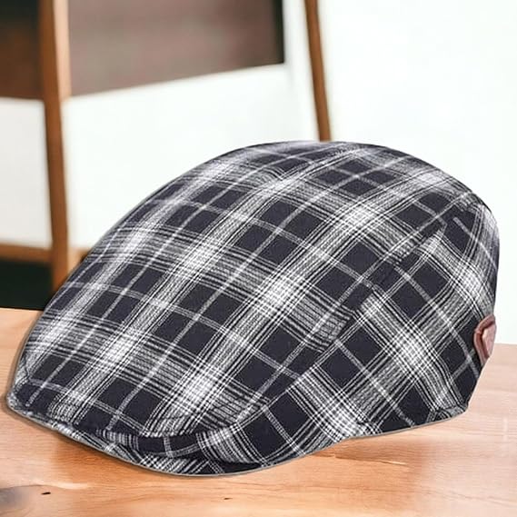 Plaid flat cap worn by a person sitting on a wooden chair.