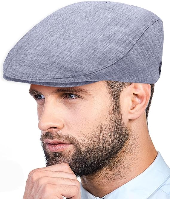 Man wearing a gray flat cap against a white background