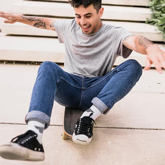 Man skateboarding on a wooden surface showcasing how comfortable the socks really are.
