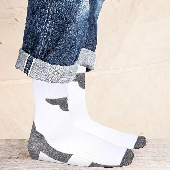 White socks with gray accents worn with rolled-up jeans on a wooden floor.