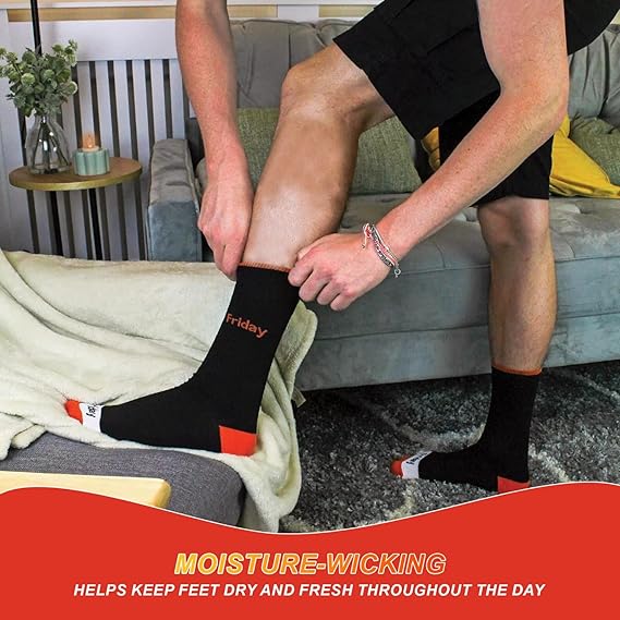 Person putting on a black sock with red accents, sitting on a couch.