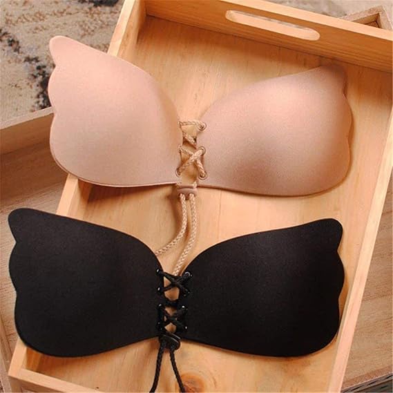 Black and beige strapless bras on a wooden tray