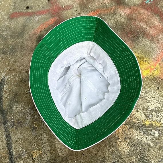 Green and white bucket hat on a textured surface