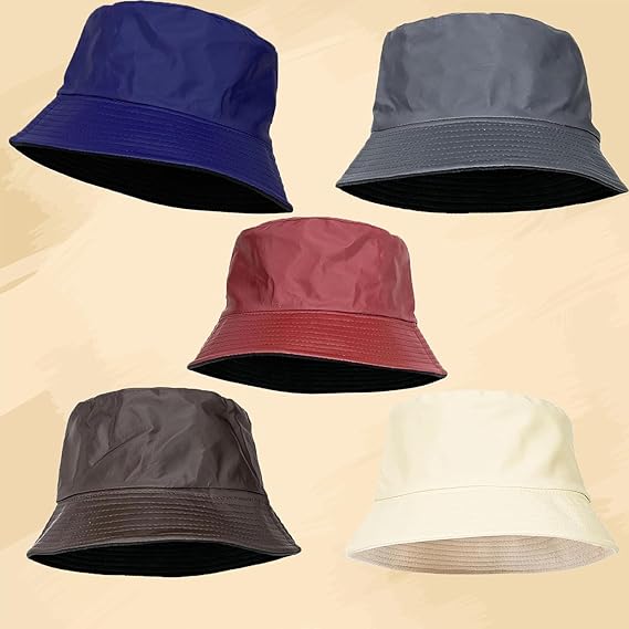 Five bucket hats in Blue, Grey, Maroon, Brown and Beige on a beige background