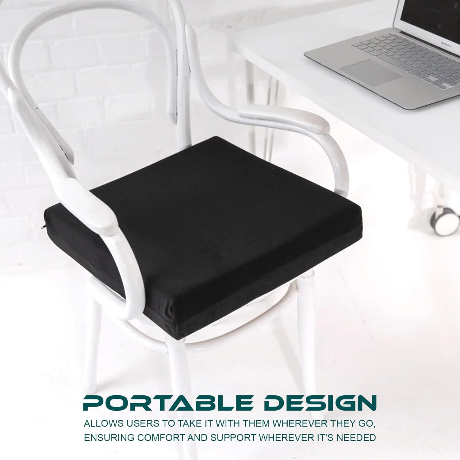 Black seat cushion on a white chair with a laptop on a table in the background.
Telling that the cushion is portable