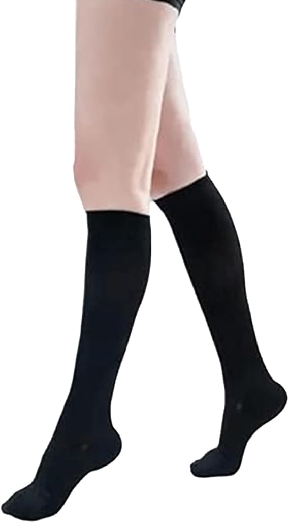 Black knee-high socks worn by a person on a white background